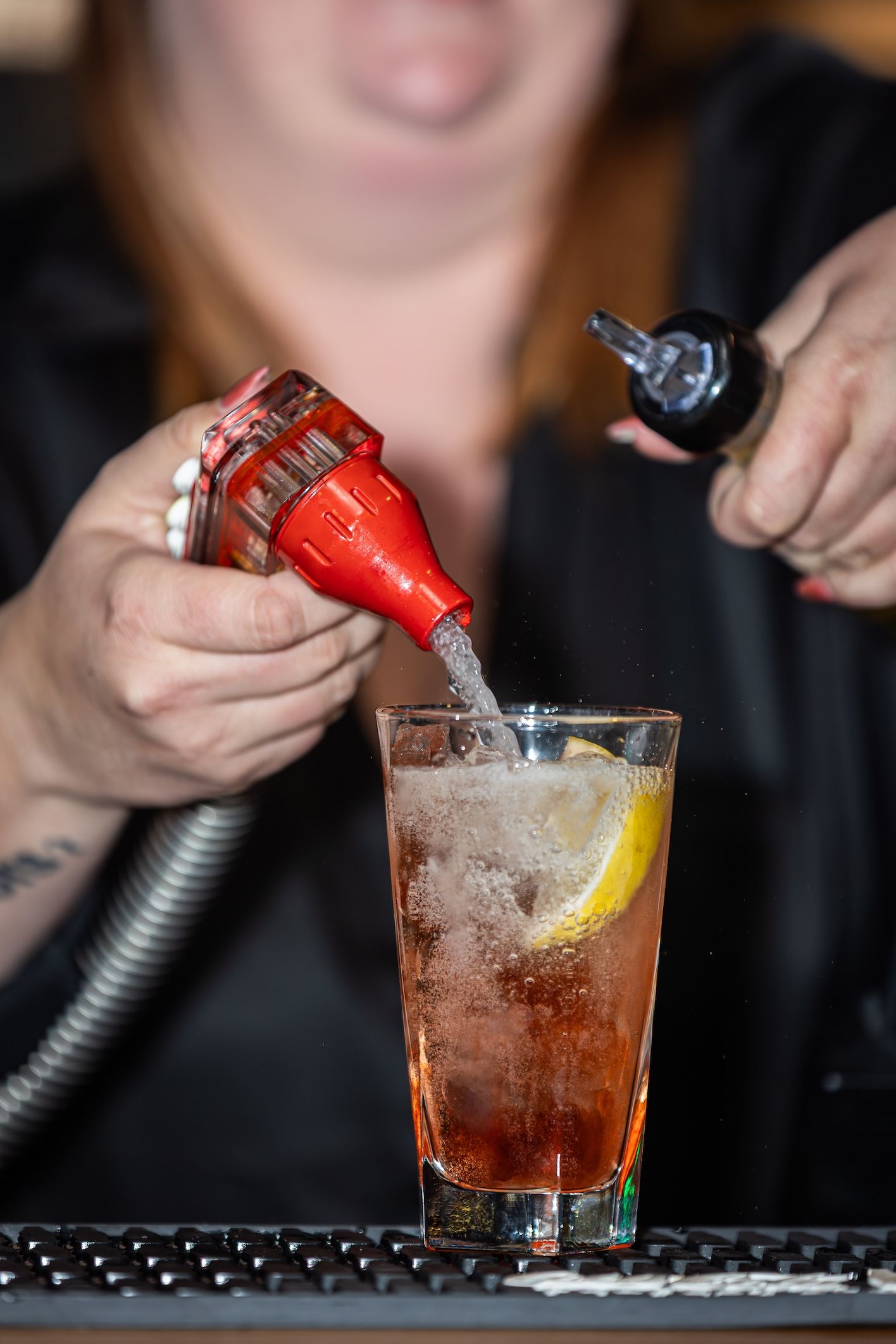 A series of photos showing the step-by-step process of pouring and garnishing a cocktail with citrus and carbonation.