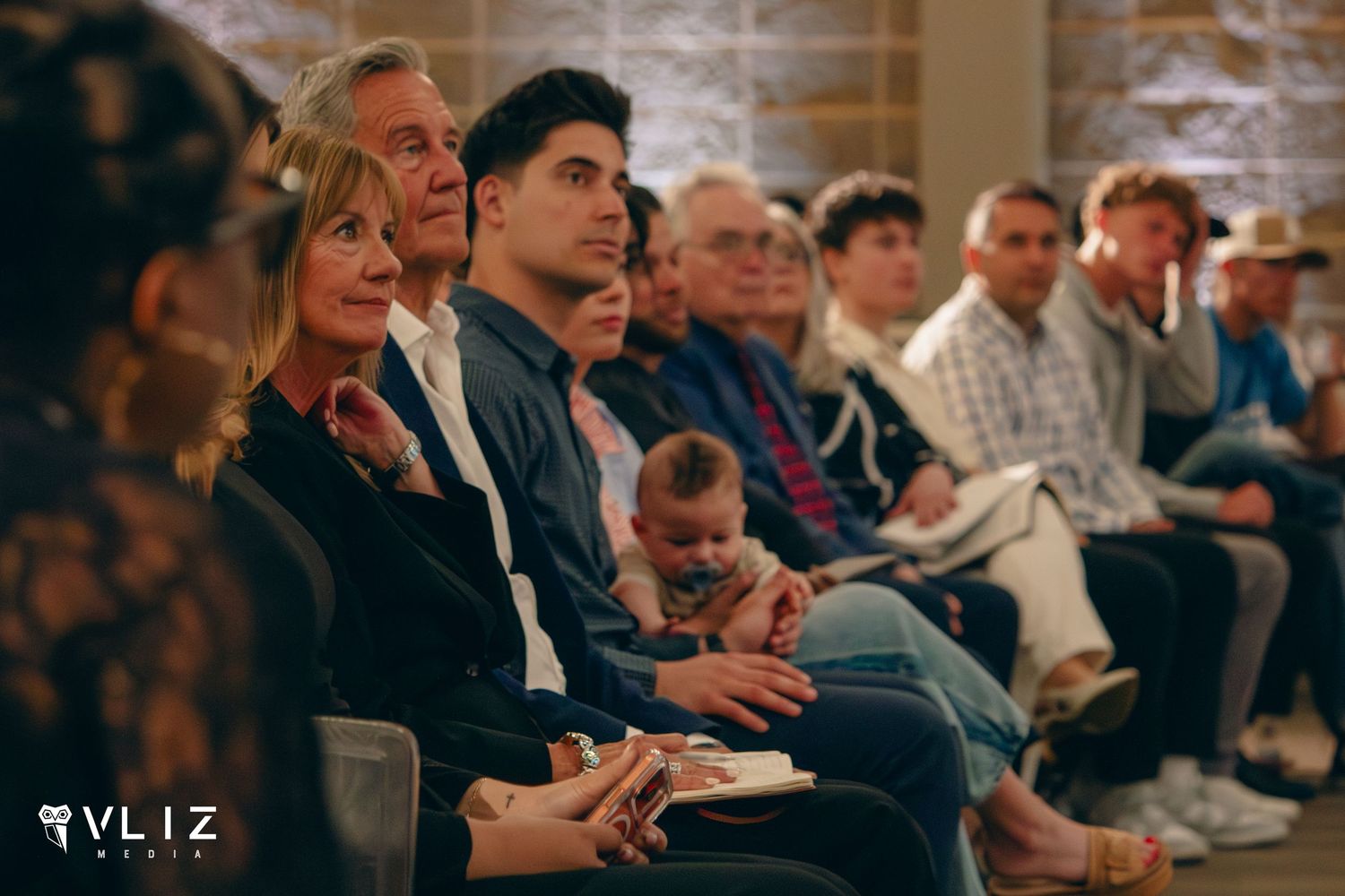 Audience members seated in rows attentively watching a presentation at a VLIZ event.