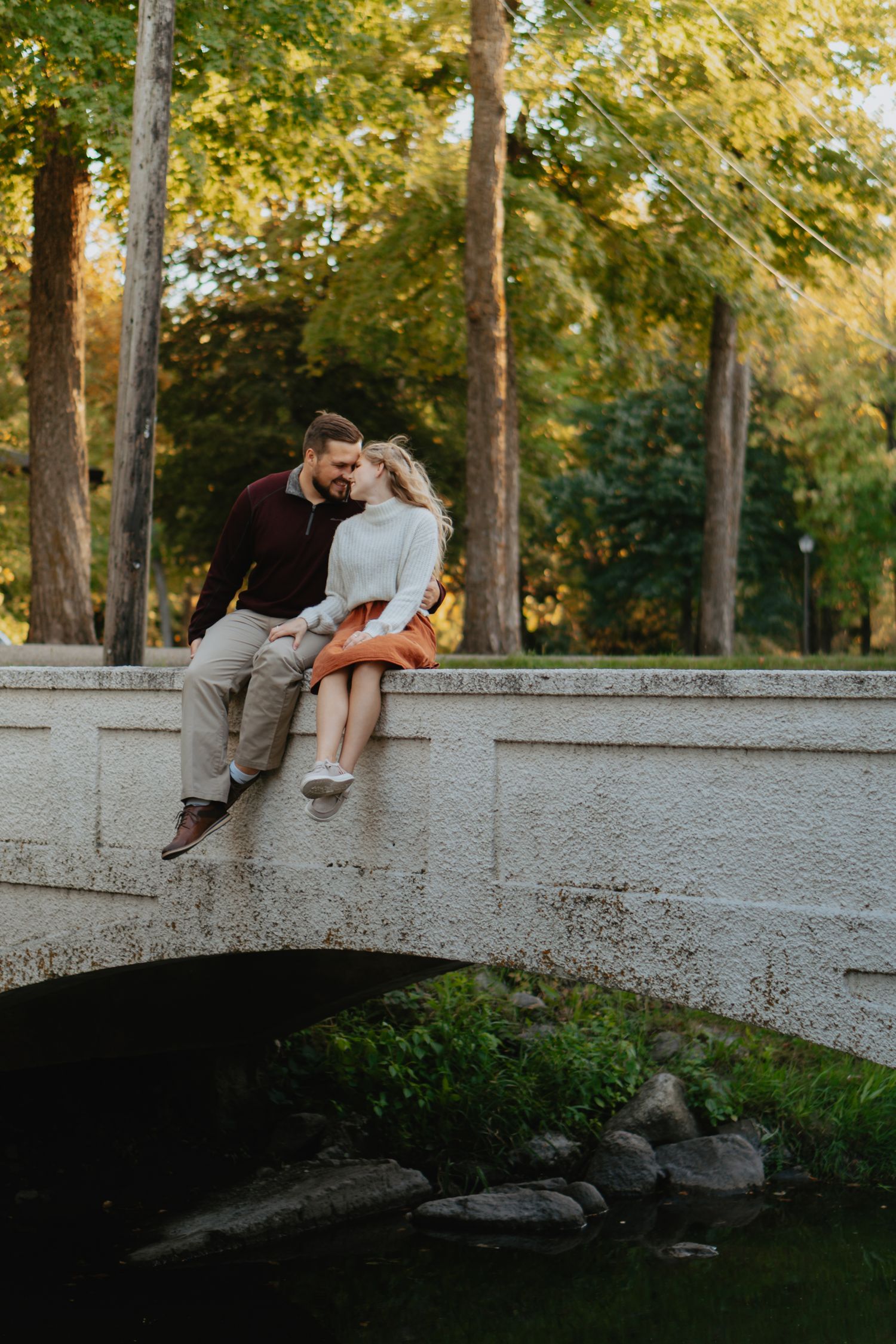 Couple sitting on a bridge