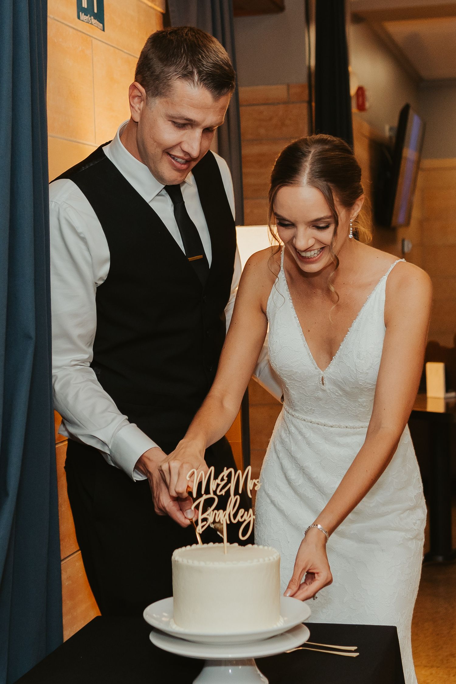 Bride and groom cutting their cake.