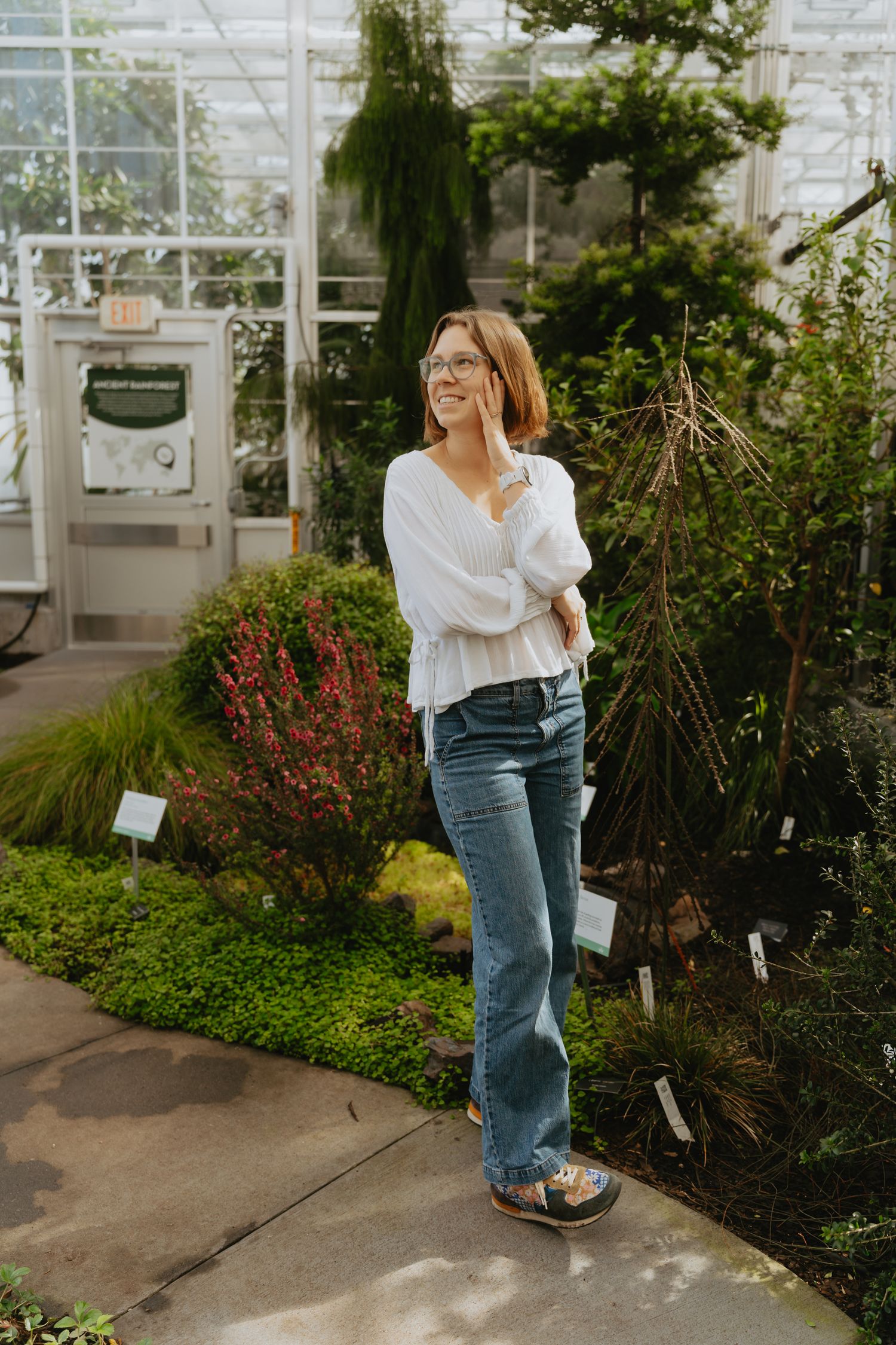 Artist standing in a conservatory