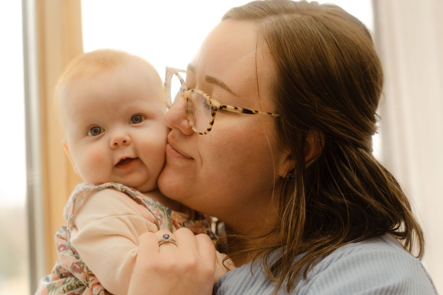 Mom holding baby up to her cheek