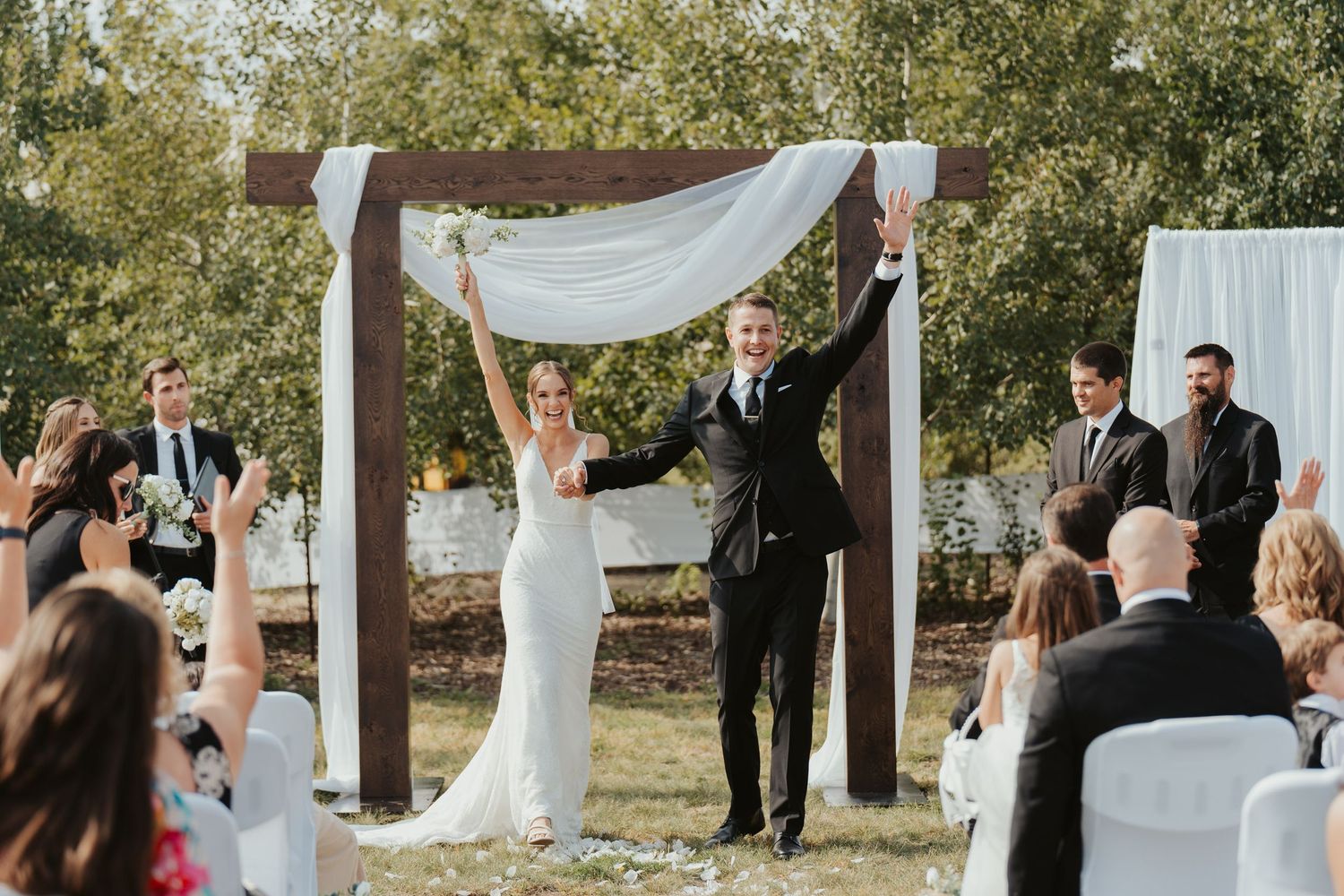 Bride and groom celebrate after officially being announced as married.