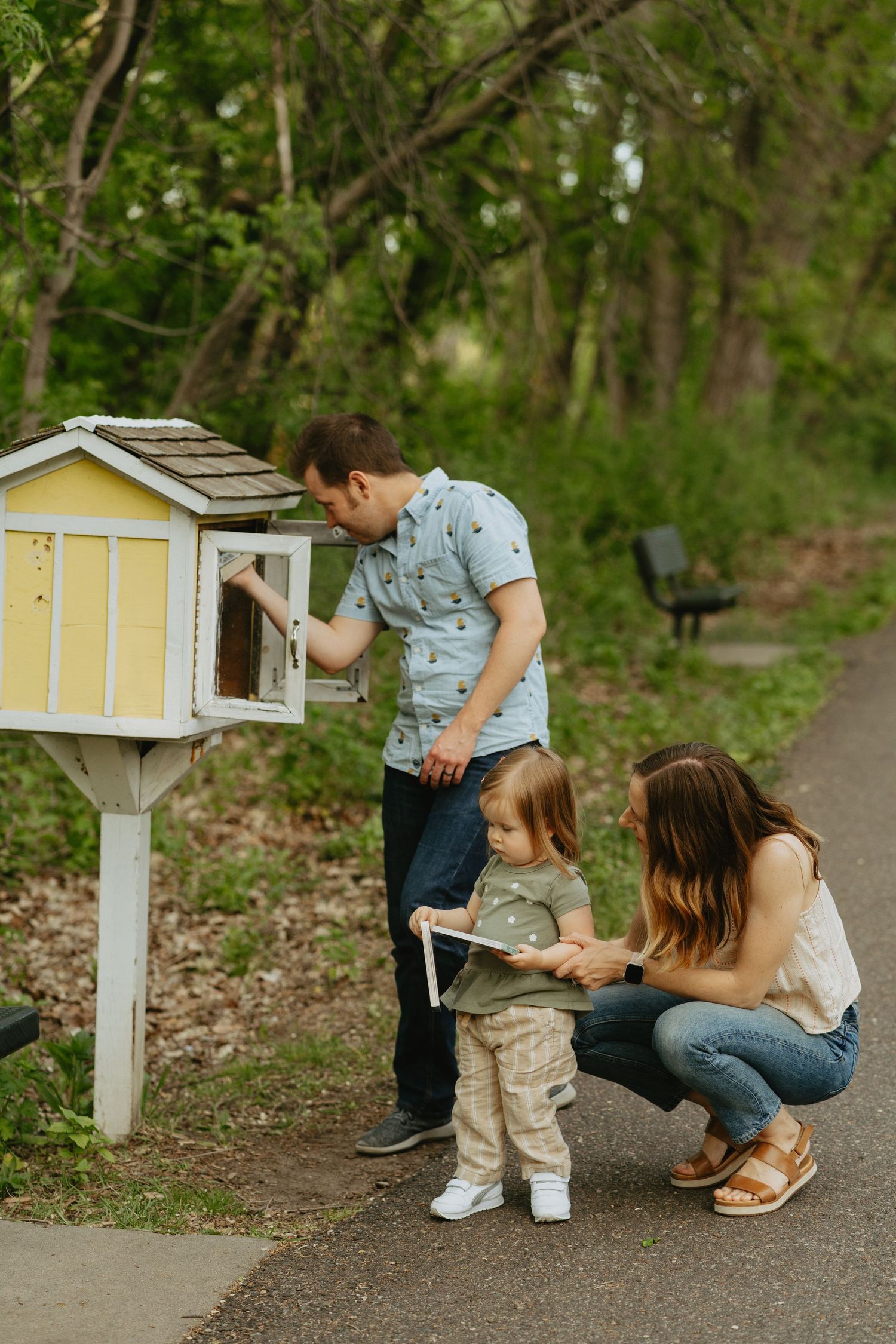 Family looking at books at a Little Free Library