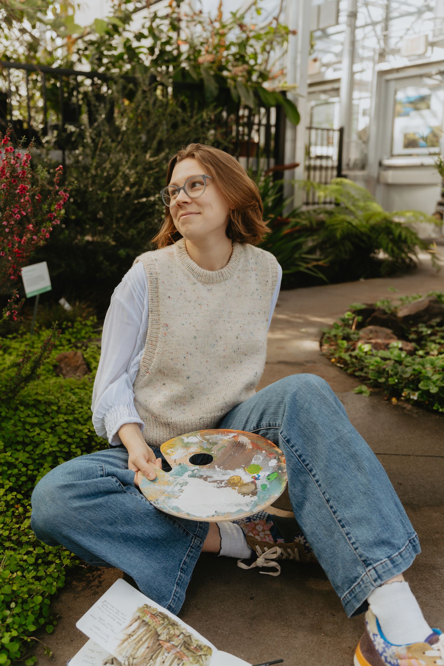 Artist posing in a conservatory