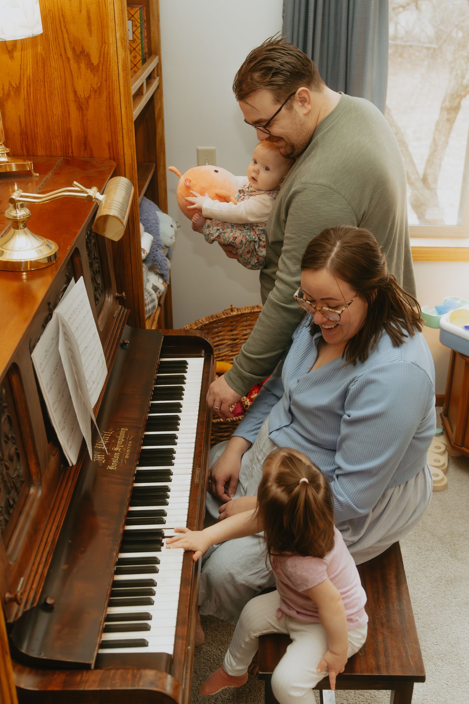 Family playing the piano together