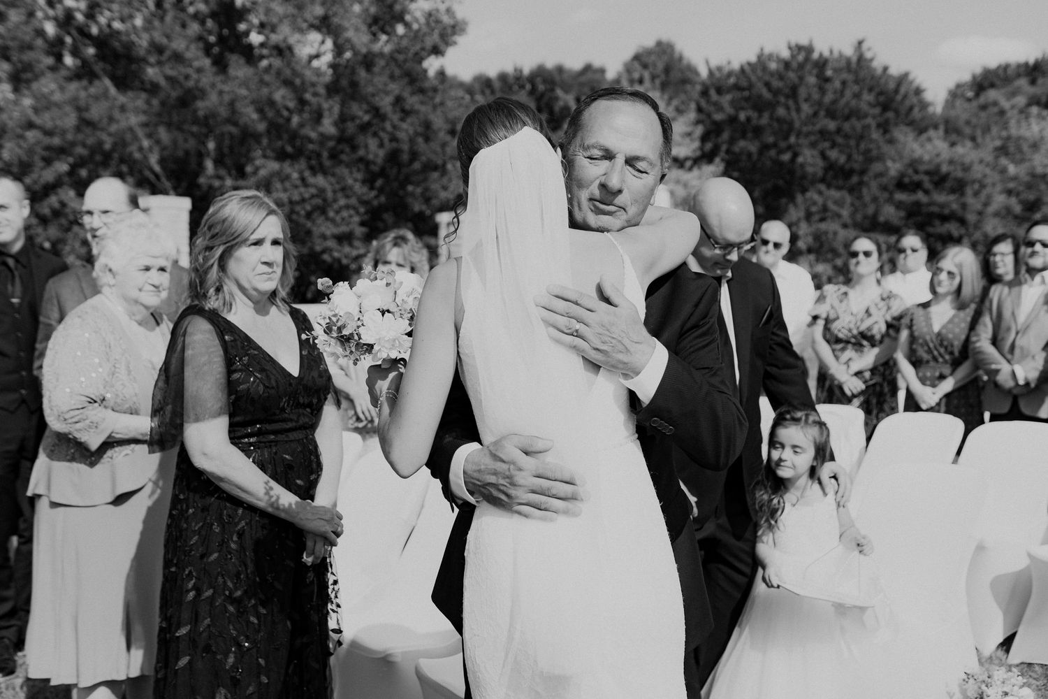 Bride and her father hug after he walks her down the aisle.