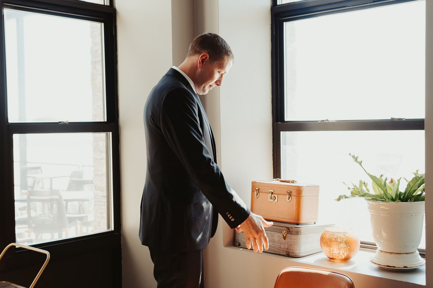 Groom adjusts cuff links as he gets ready for his first look.