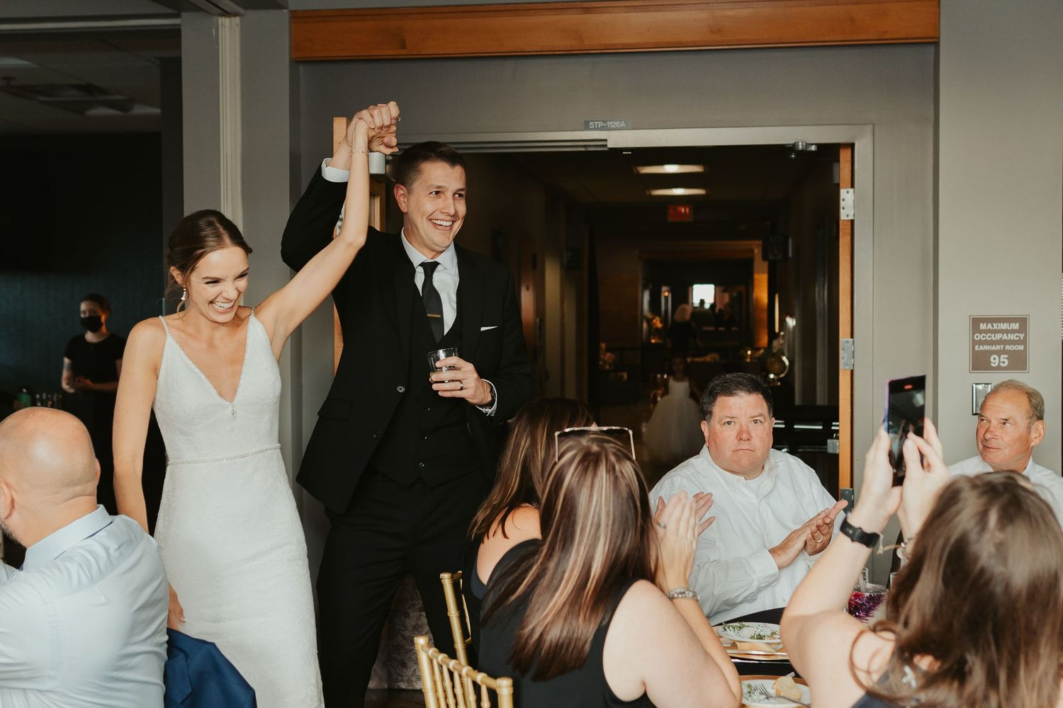 Bride and groom entering their reception.