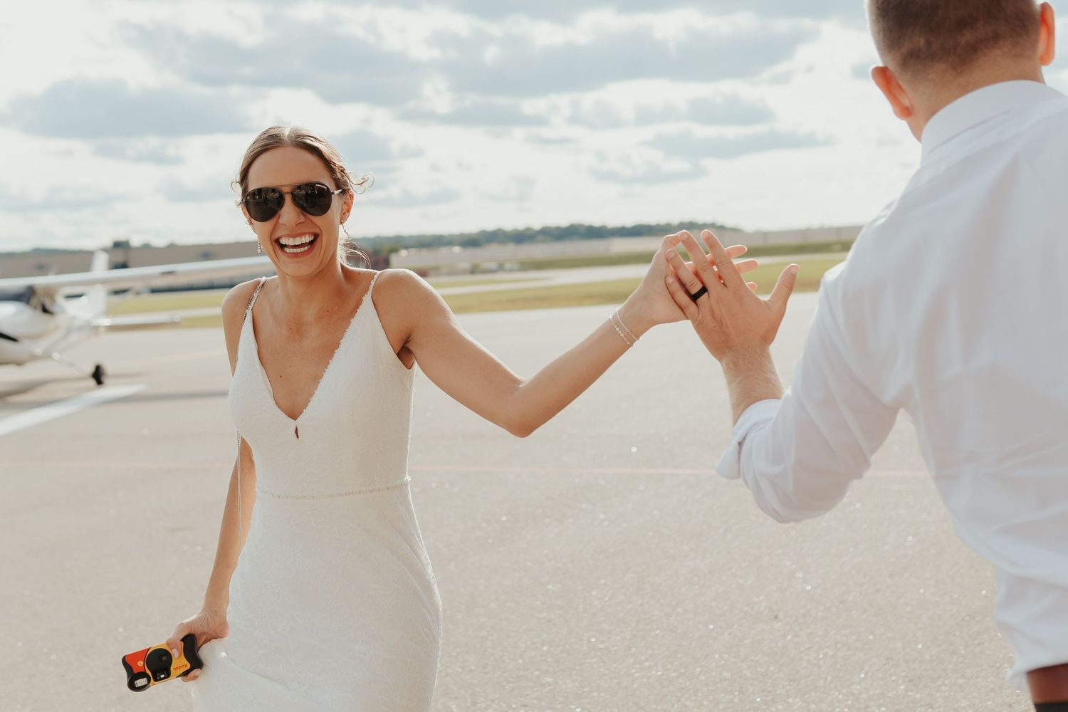 Bride high fives wedding guest.