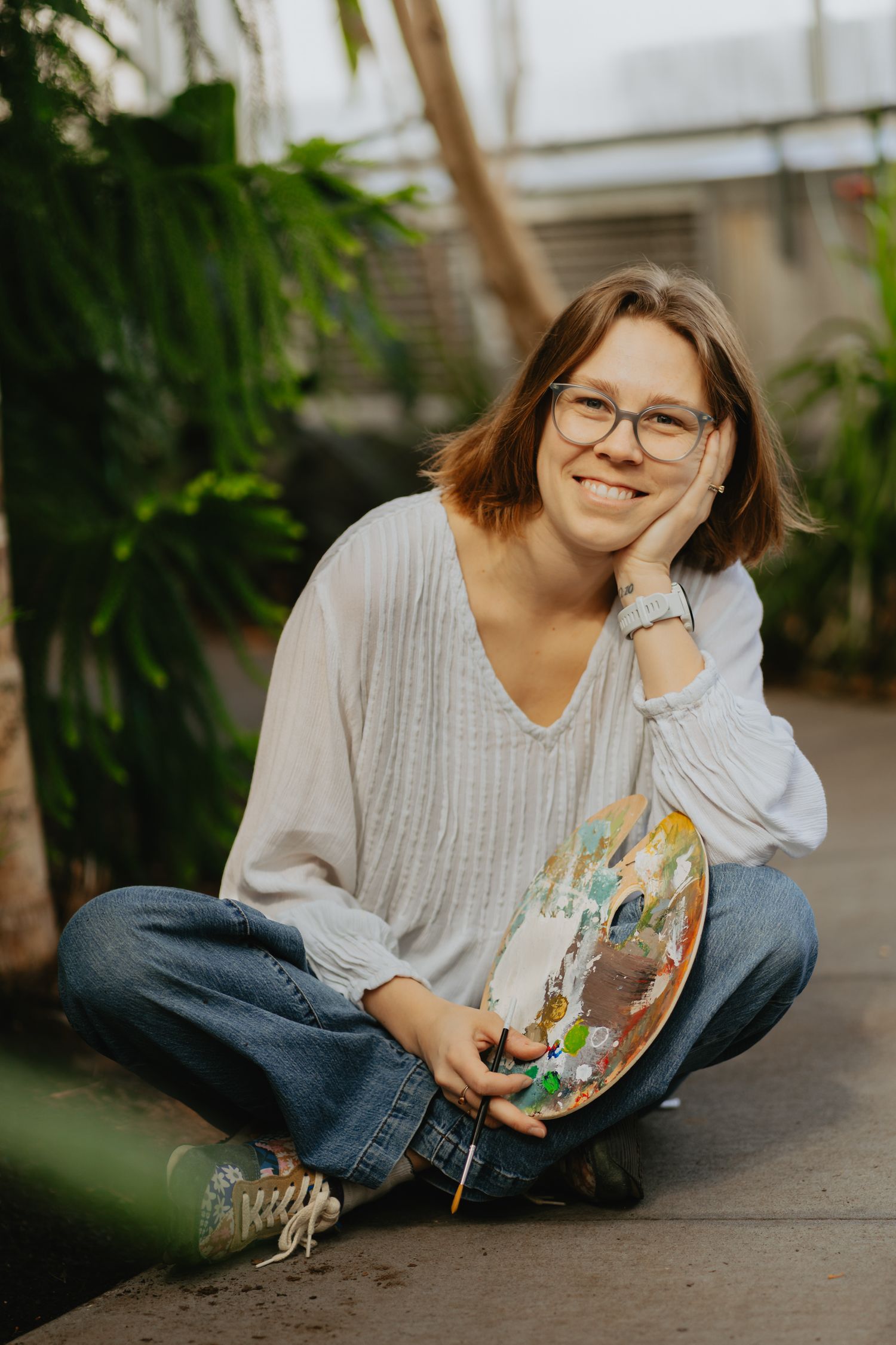 Artist posing in a conservatory