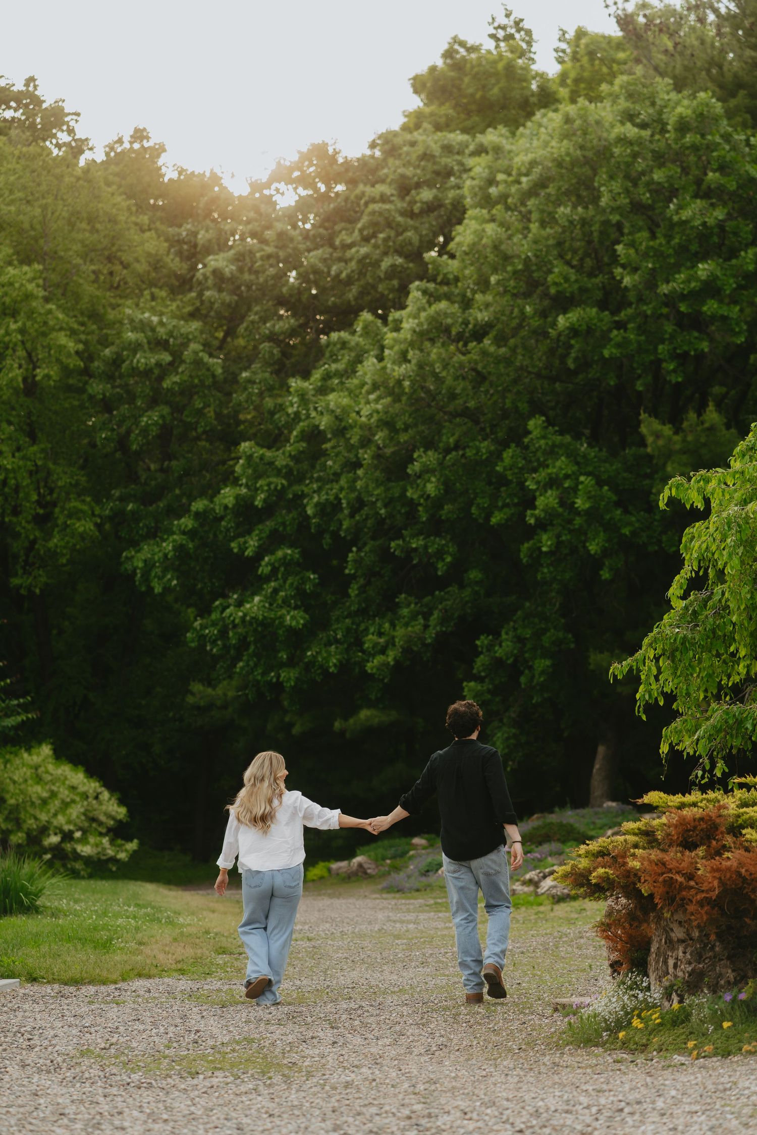 Couple holding hands and walking along a path