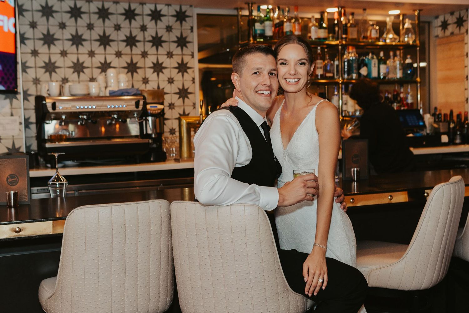 Bride and groom posing at the bar.