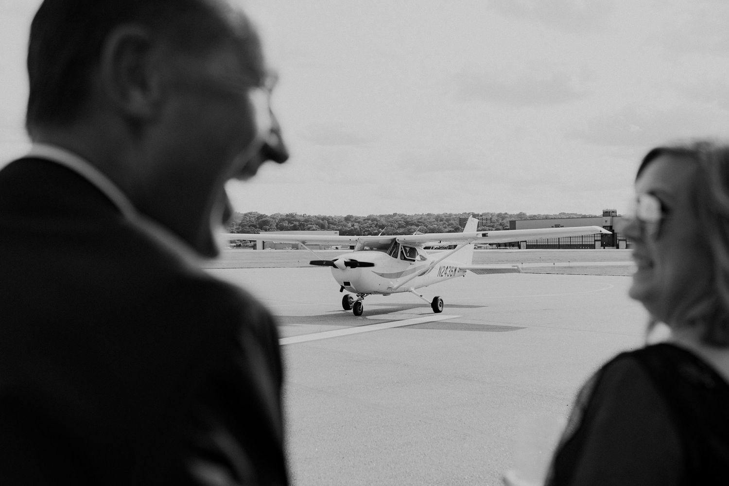 Parents of the bride cheering as the bride and groom land after taking a short private plane right around St. Paul.