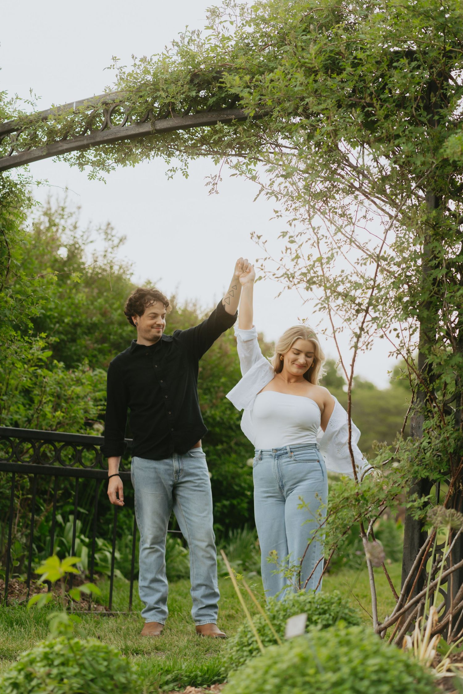 Couple dancing outside under an arch