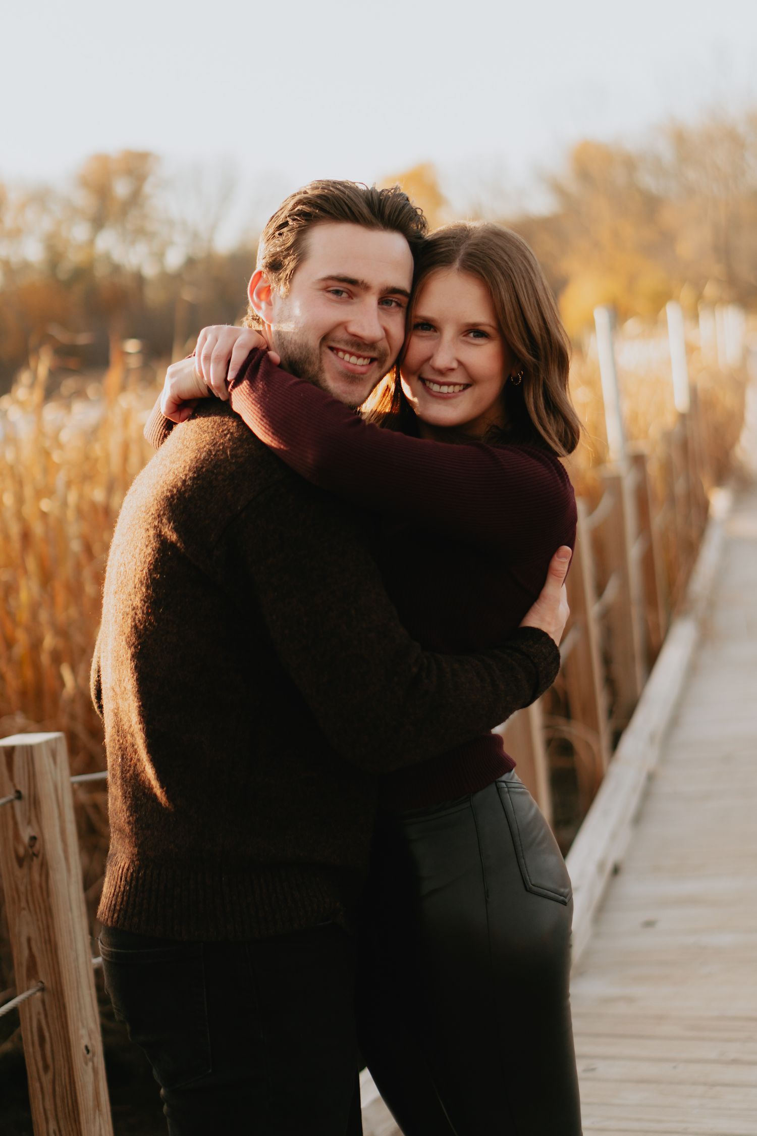 Couple posing on a bridge