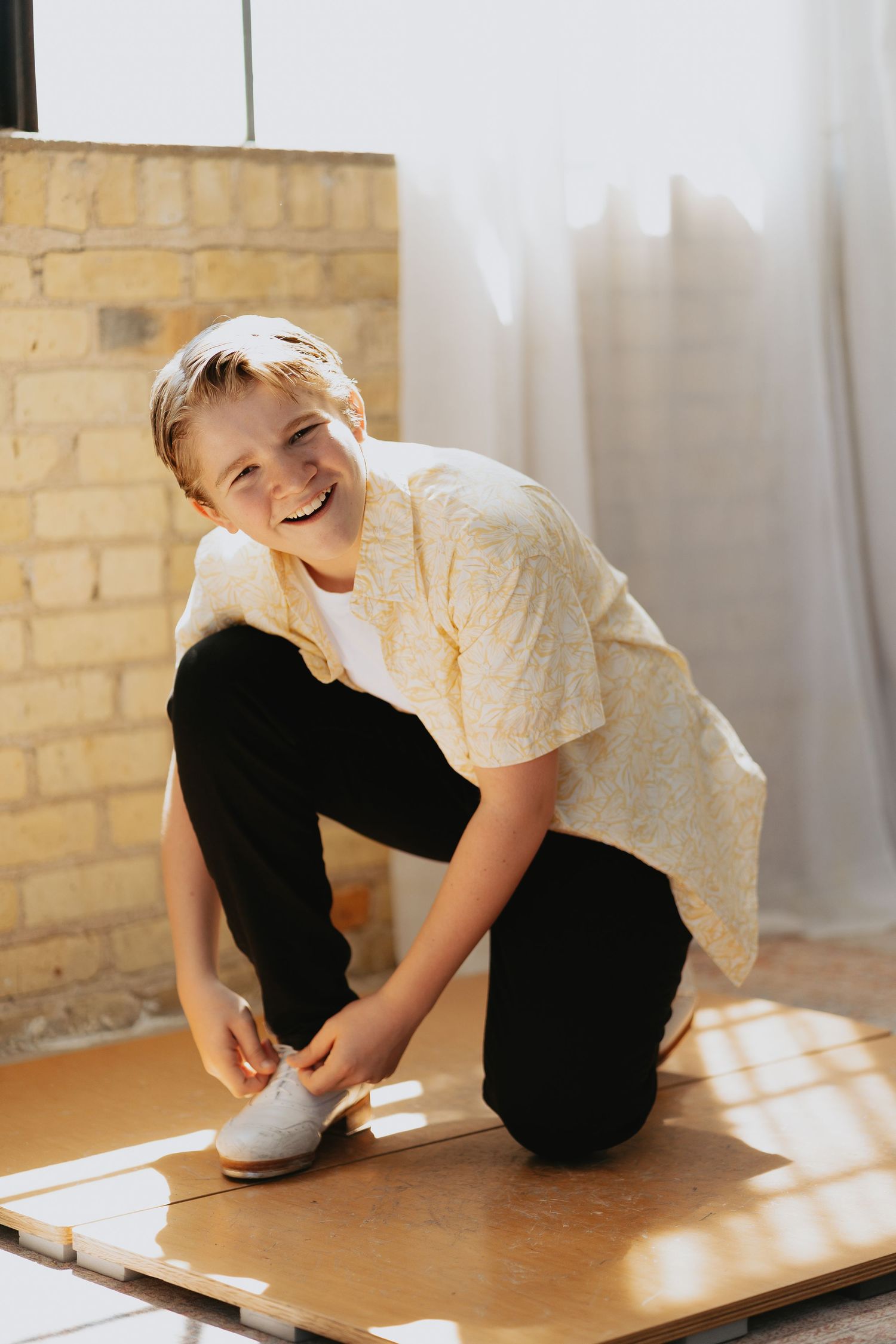 Boy putting on tap shoes