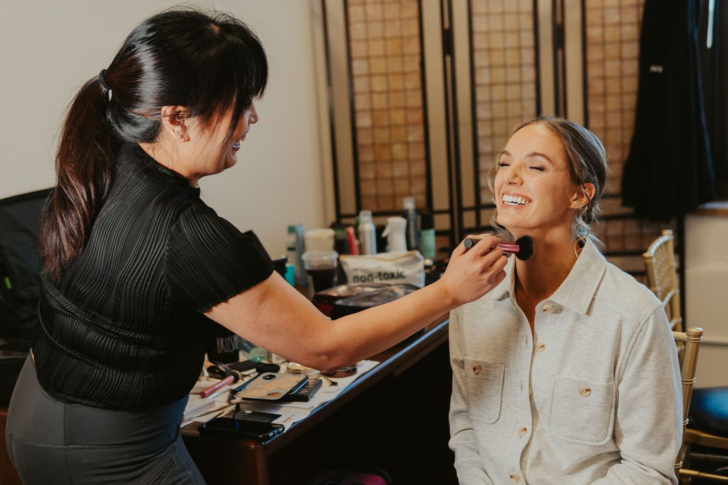 Bride gets the final touches of her makeup done.