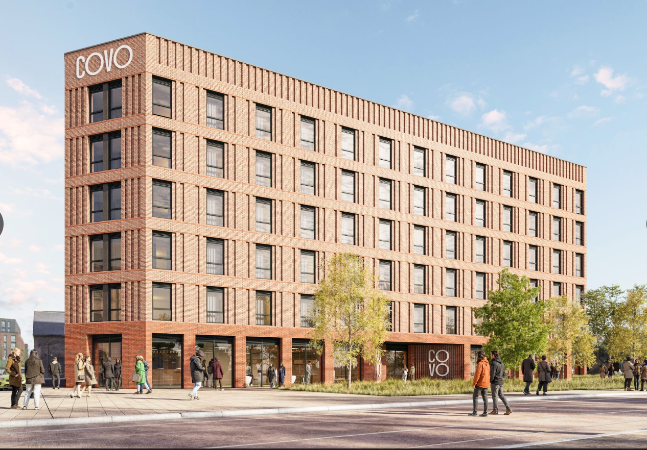 Modern NOVO branded multi-story brick apartment building with ground floor retail spaces and pedestrians in an urban setting.