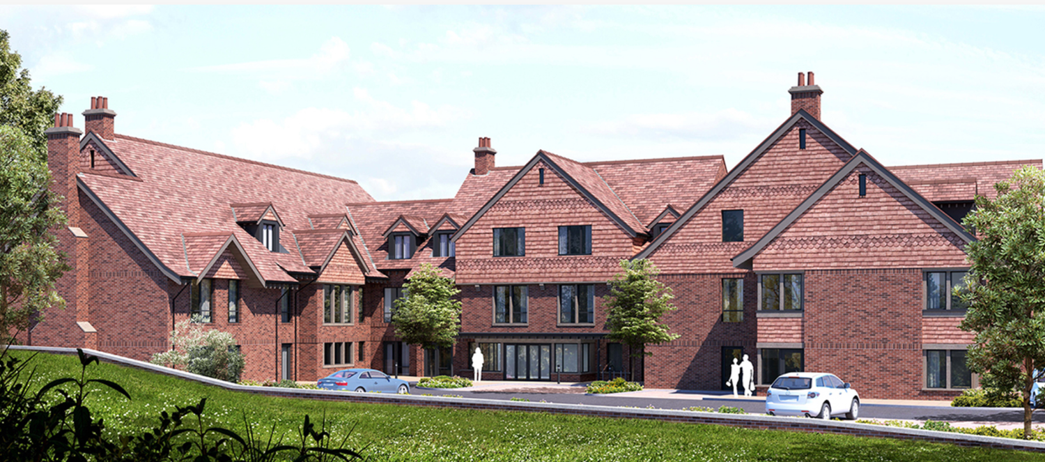 Modern brick townhouses with red tiled roofs and dormer windows in a residential development.