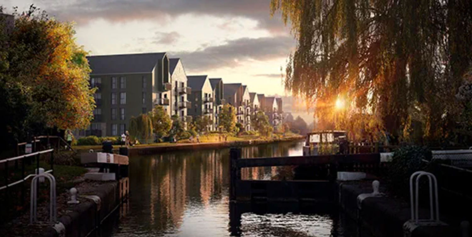 Golden sunset reflects on a calm canal beside modern townhouses framed by autumn trees and weeping willows.