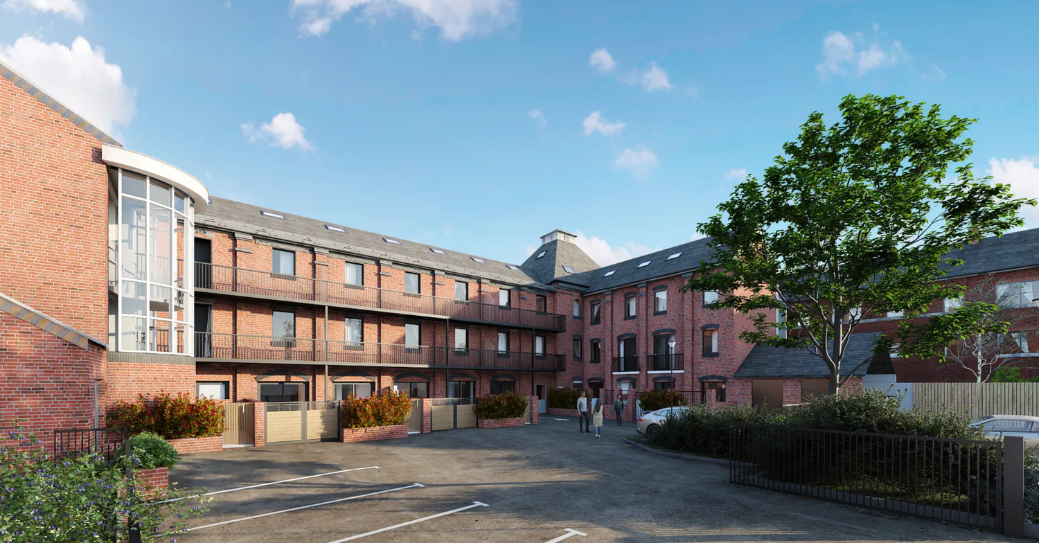 Modern brick residential apartment complex with courtyard, balconies, and mature trees under a clear blue sky.