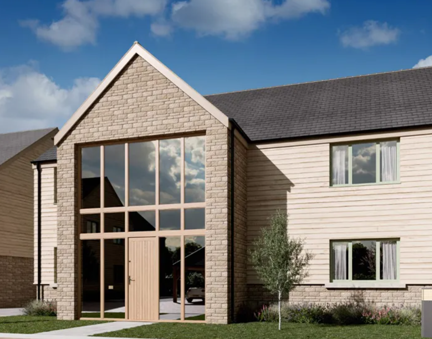 Modern new-build home with stone gable facade, large floor-to-ceiling windows, and light wood cladding under blue skies.