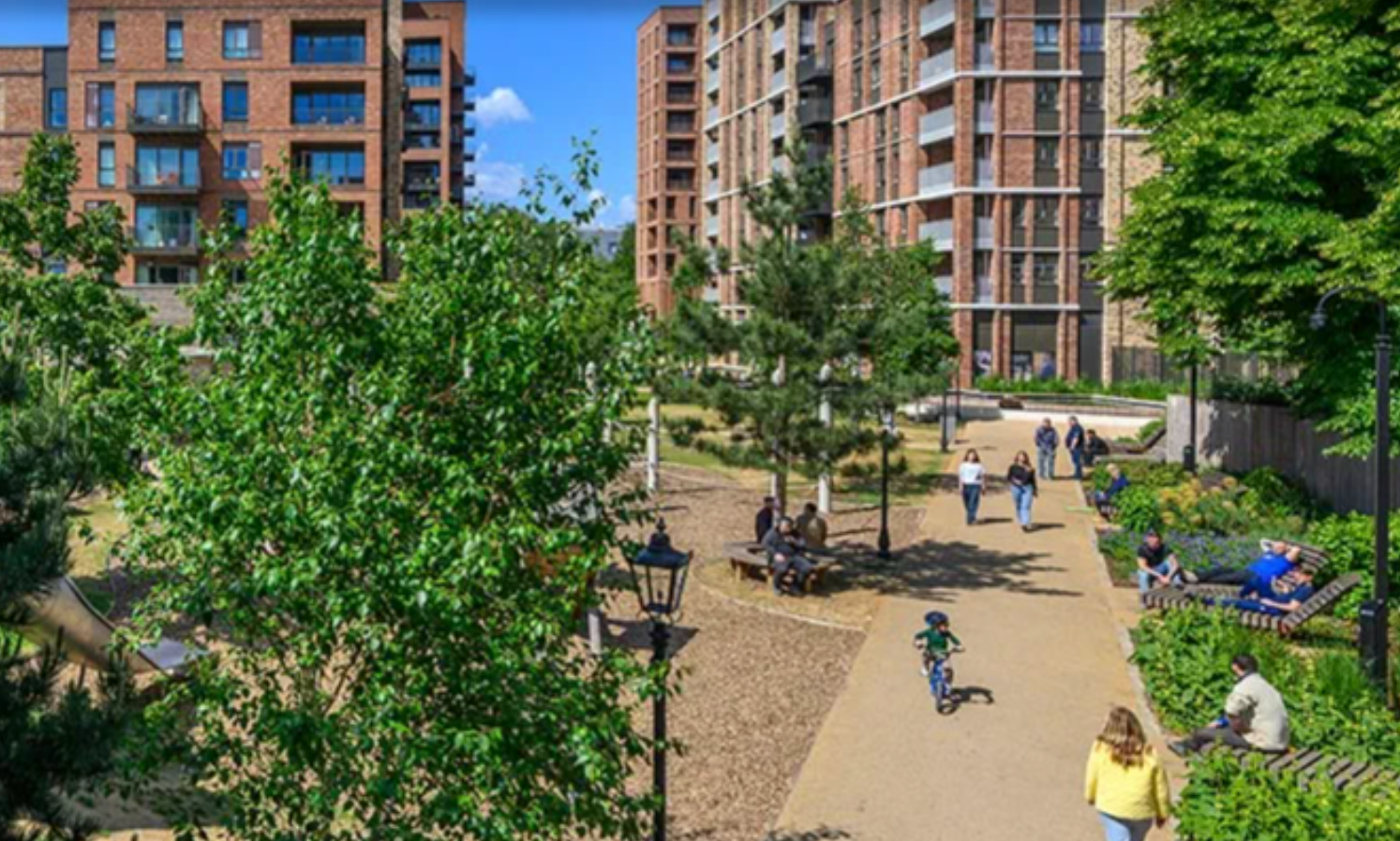 Modern urban apartment complex with lush green park, pathways, and residents enjoying outdoor spaces on a sunny day.