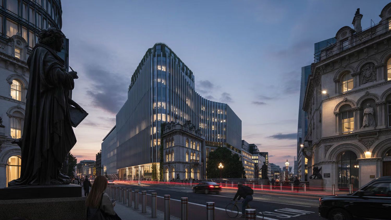 Modern glass office building illuminated at dusk in an urban cityscape with historic architecture and light trails.