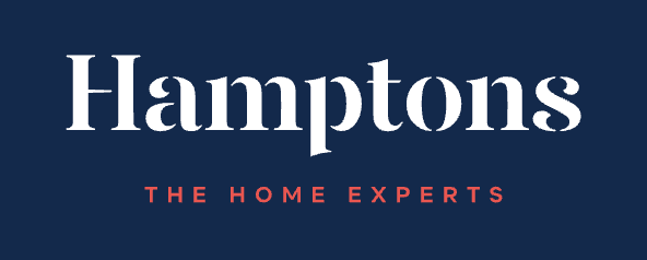 Hamptons The Home Experts logo in white serif font on a navy blue background with red tagline.