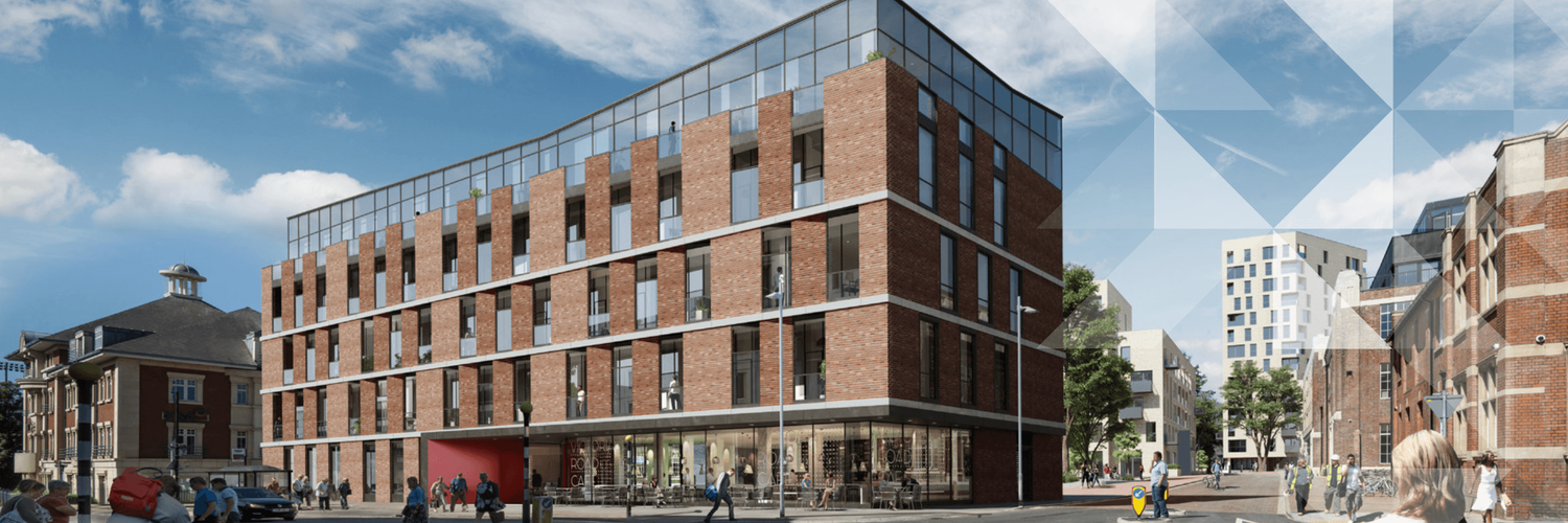 Modern brick and glass multi-story commercial building on a city street corner under a partly cloudy sky.