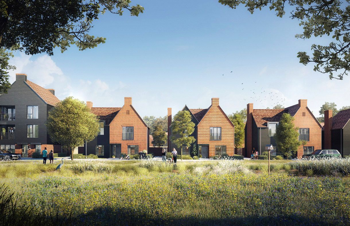 Modern brick residential houses with dark trim surrounded by mature trees and green meadows in a new housing development.