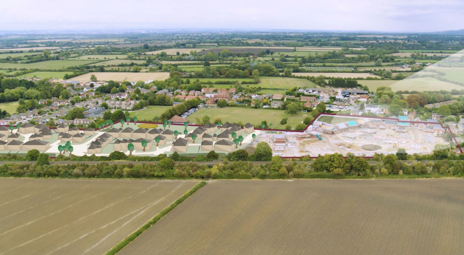 Aerial view of a rural village with new housing development, open fields, and countryside landscape under a clear sky.
