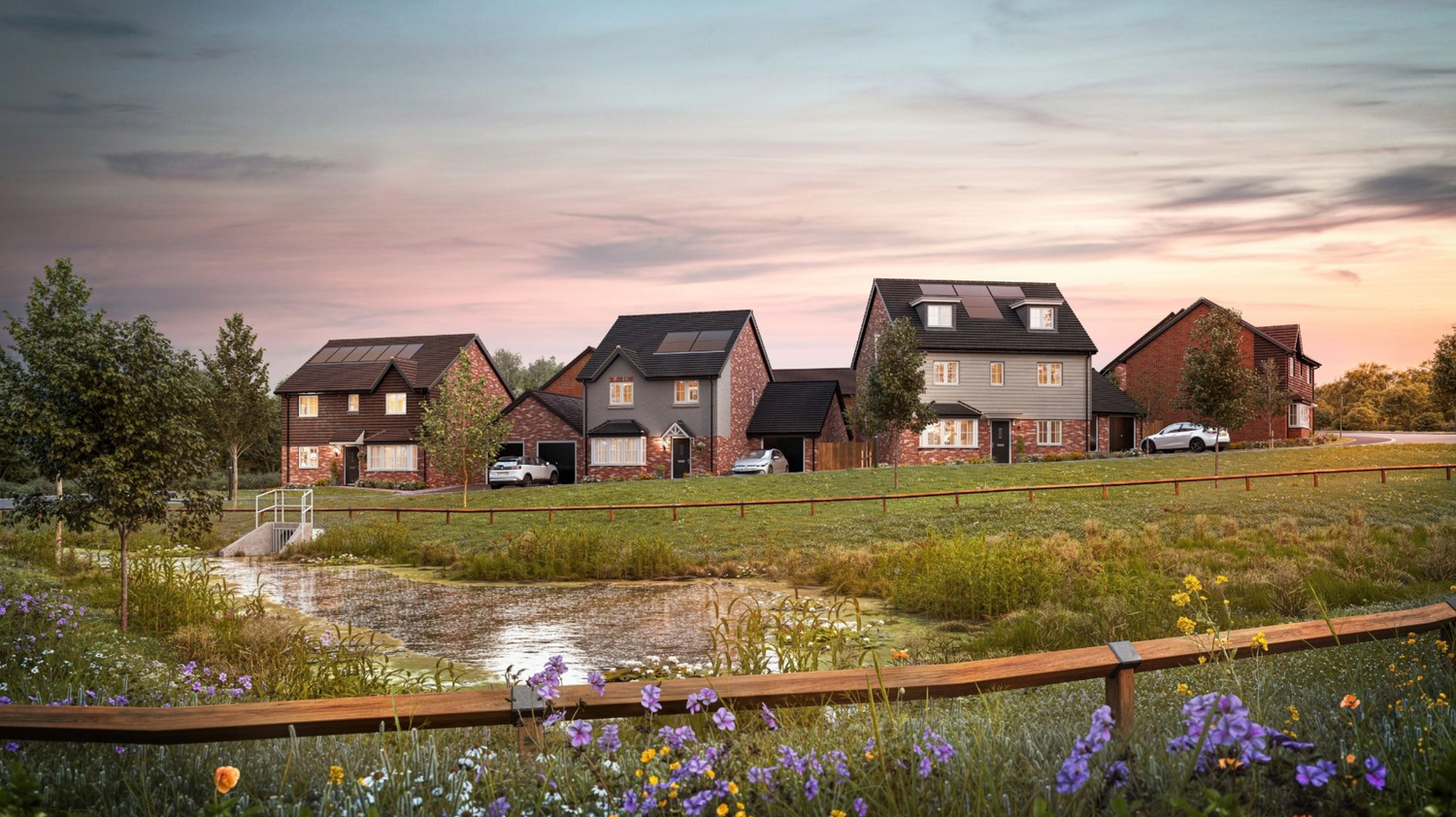 Modern residential homes with dark timber facades set against a colorful wildflower meadow at dusk.