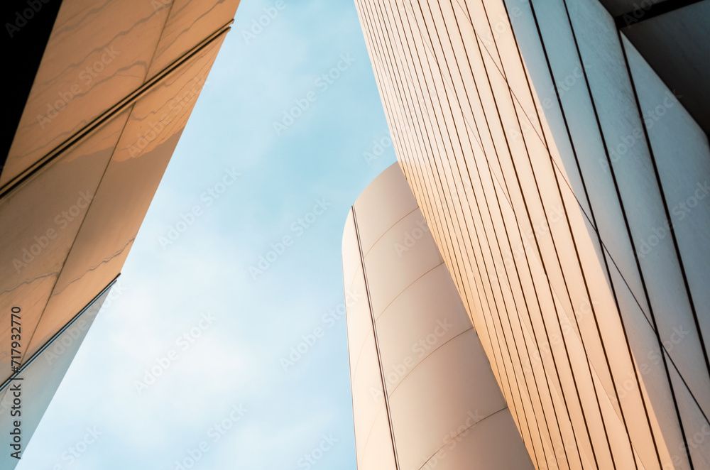 Modern architectural detail of white ribbed columns against bright sky.