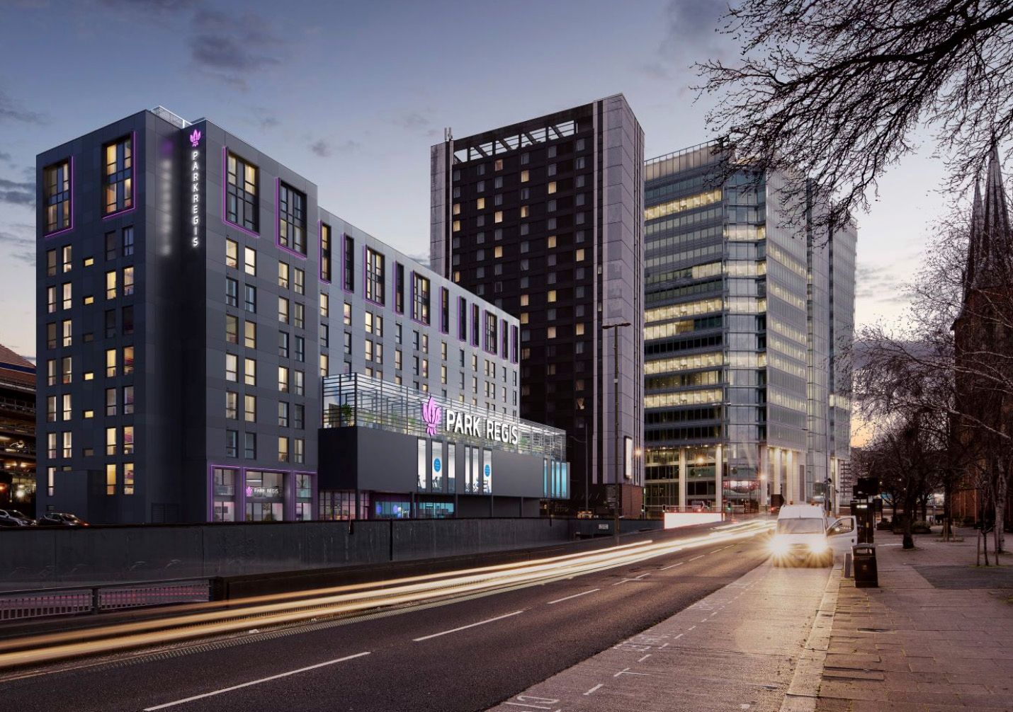 Modern hotel building exterior illuminated at dusk with light trails on busy urban street.