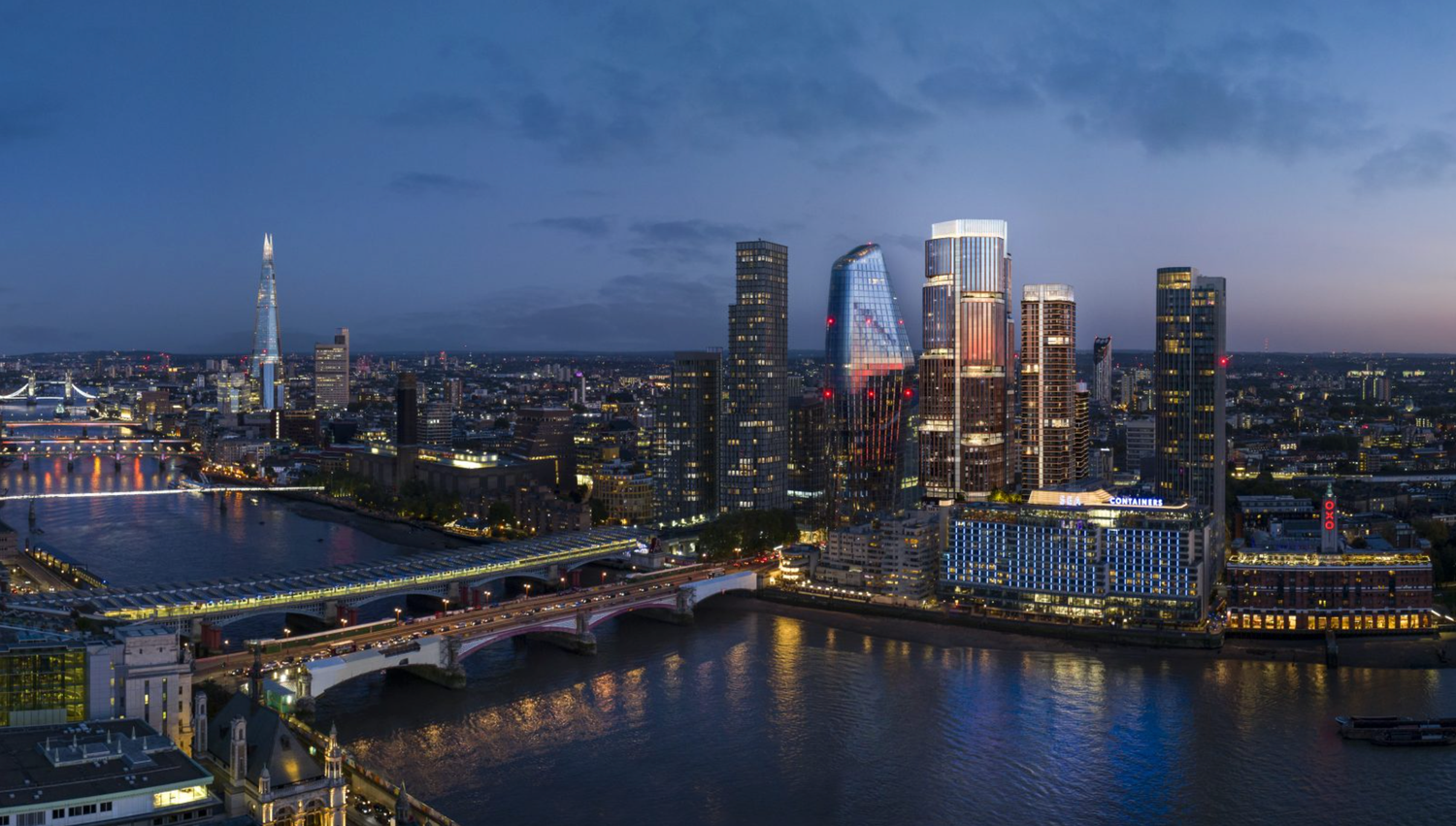 Aerial twilight view of London skyline with illuminated skyscrapers reflecting on the Thames River.