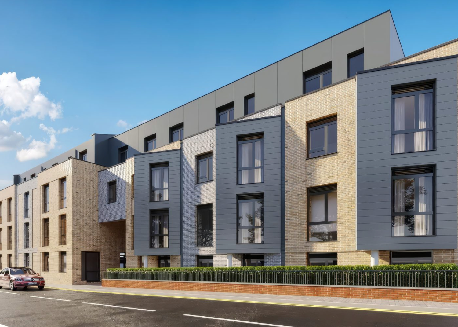 Modern residential apartment building with grey and brick facade, large windows, and landscaped frontage under blue sky.