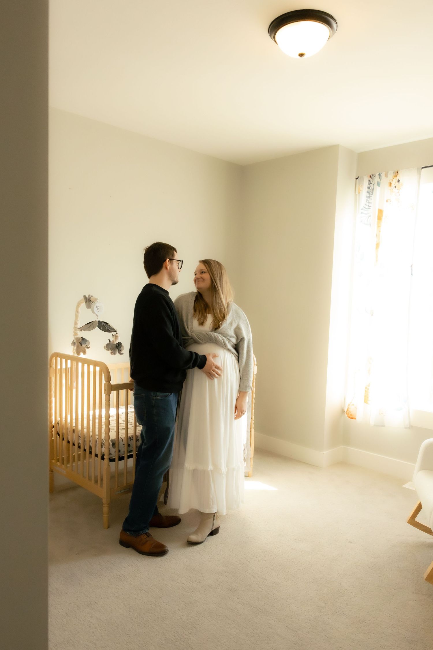 parents in nursery for maternity session