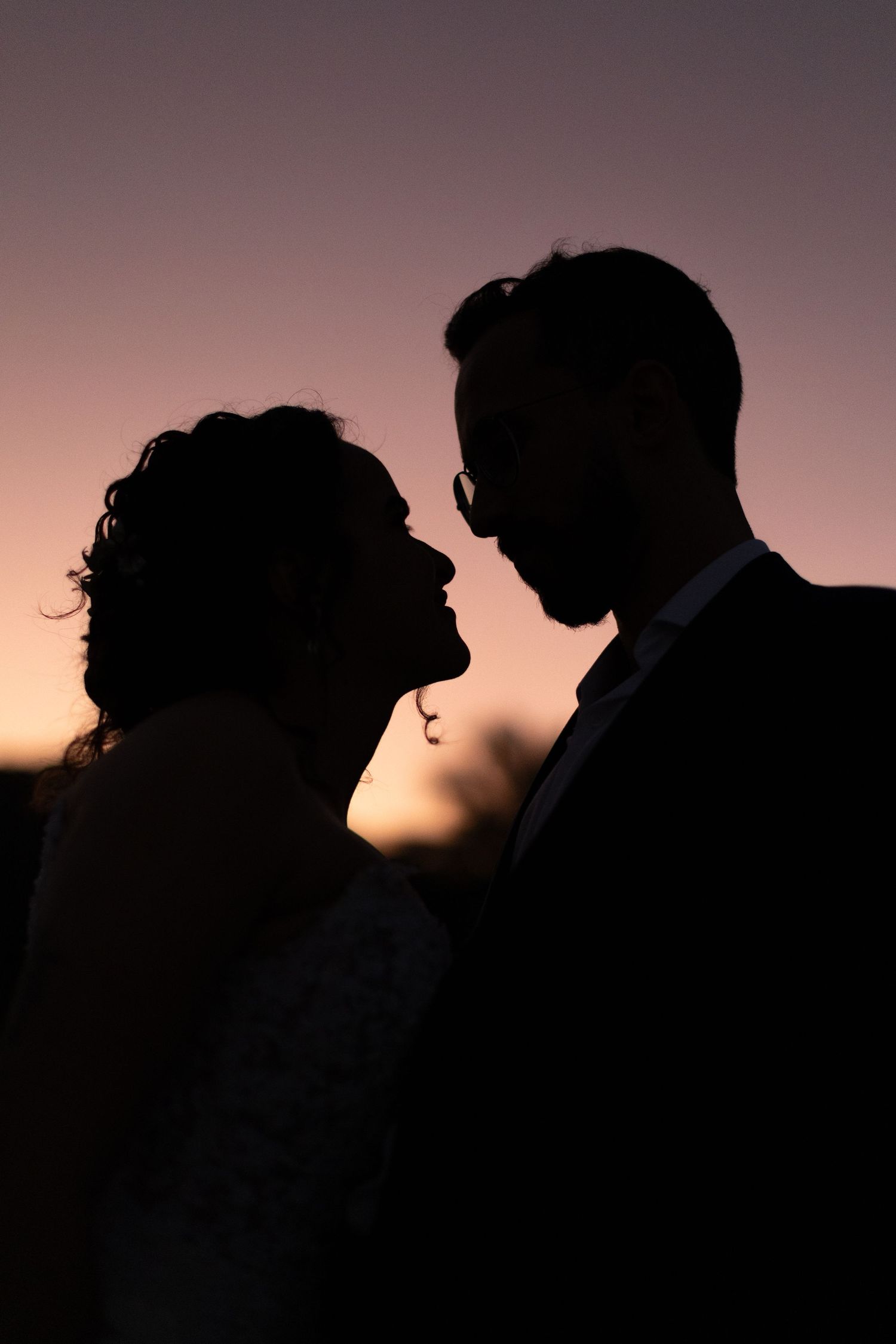 Romantic silhouette portrait of a couple at sunset.