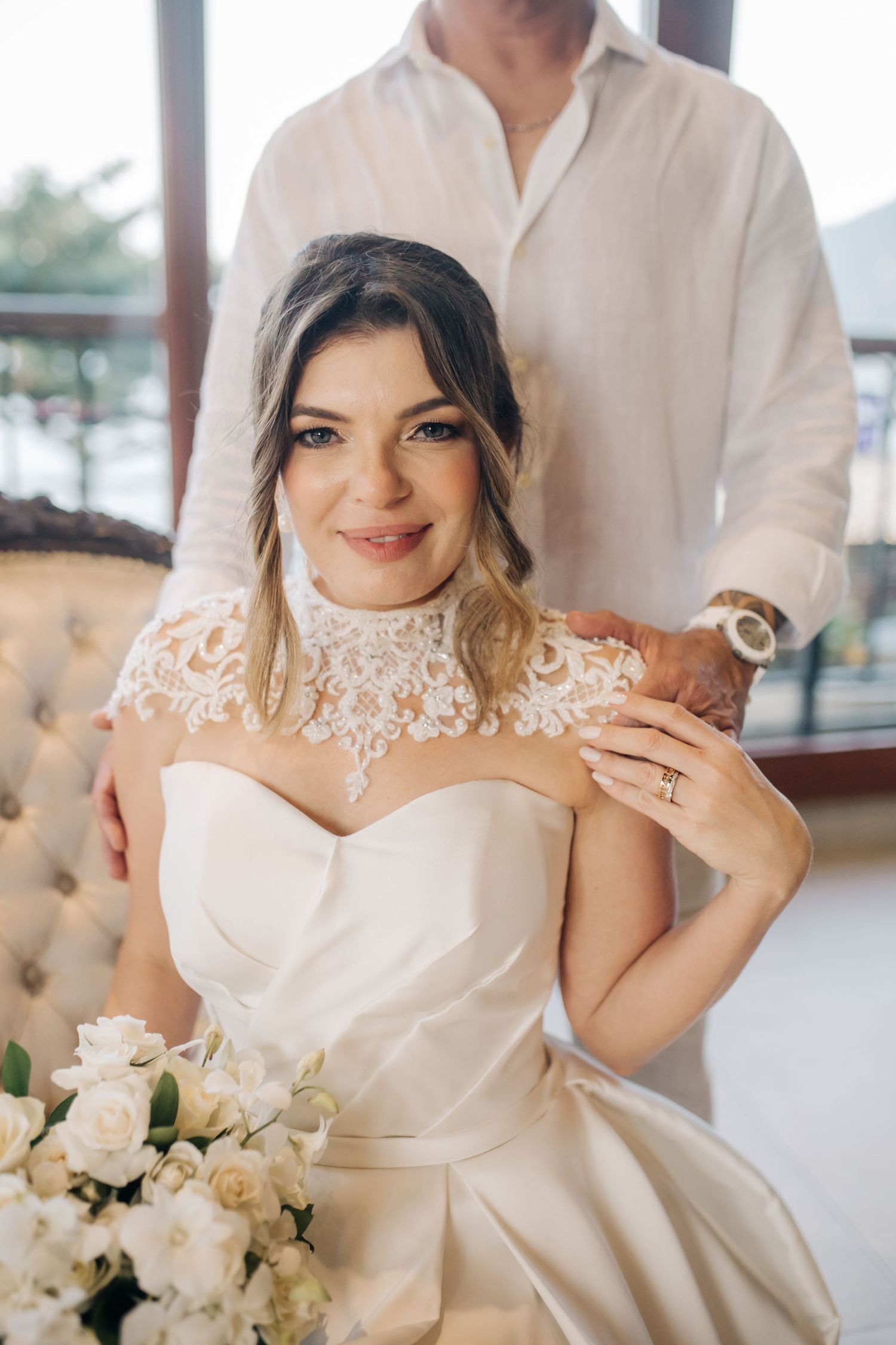Close-up details of an elegant white wedding gown with delicate lace accents.