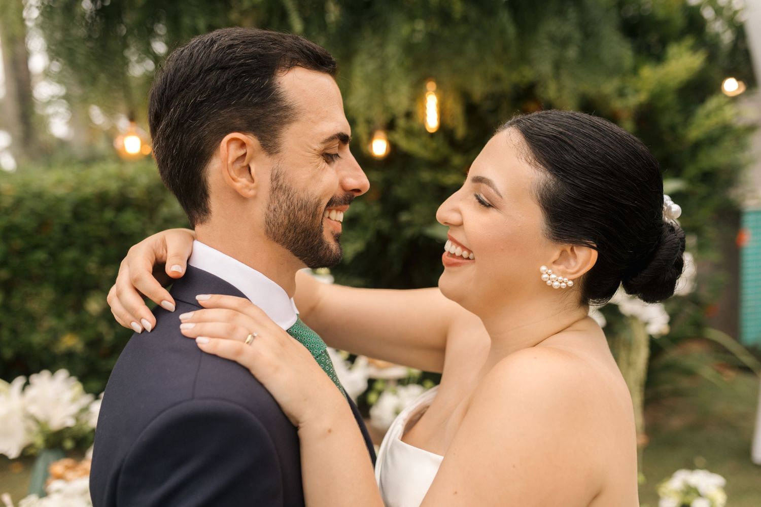 Newlyweds share an intimate moment during their first dance in a garden reception.