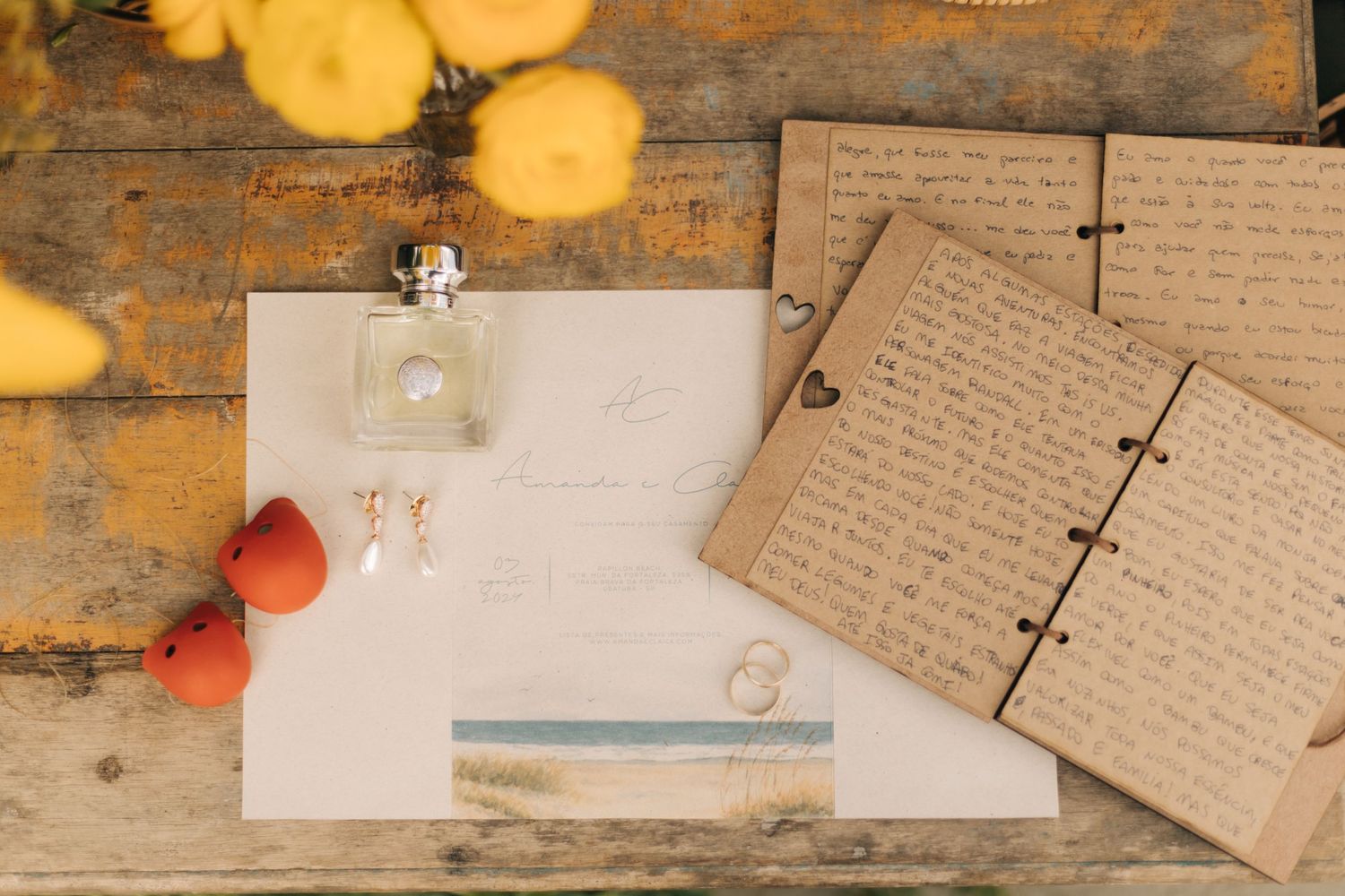 Wedding details including handwritten notes and kraft paper on a vintage wooden table.