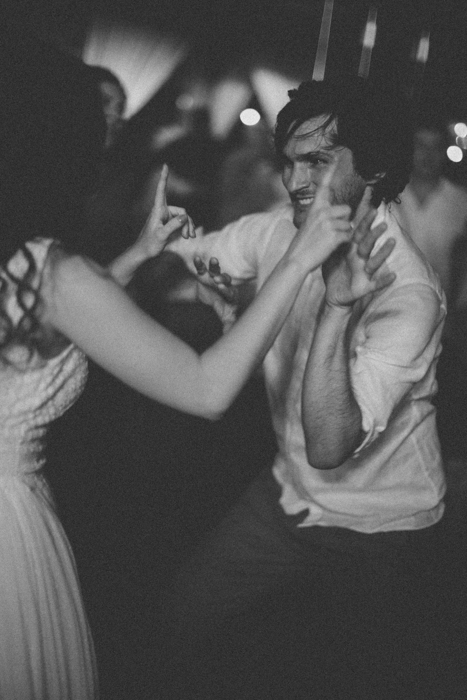 Black and white photo sequence showing dancing and laughter in a dimly lit setting.