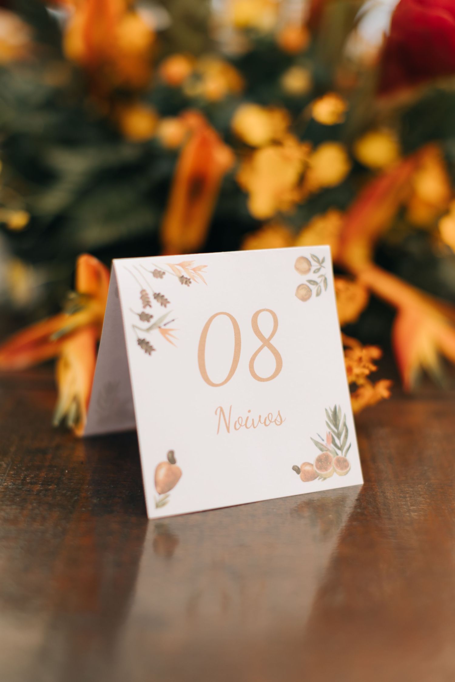 White and gold wedding table number card with botanical design elements showing number 08.