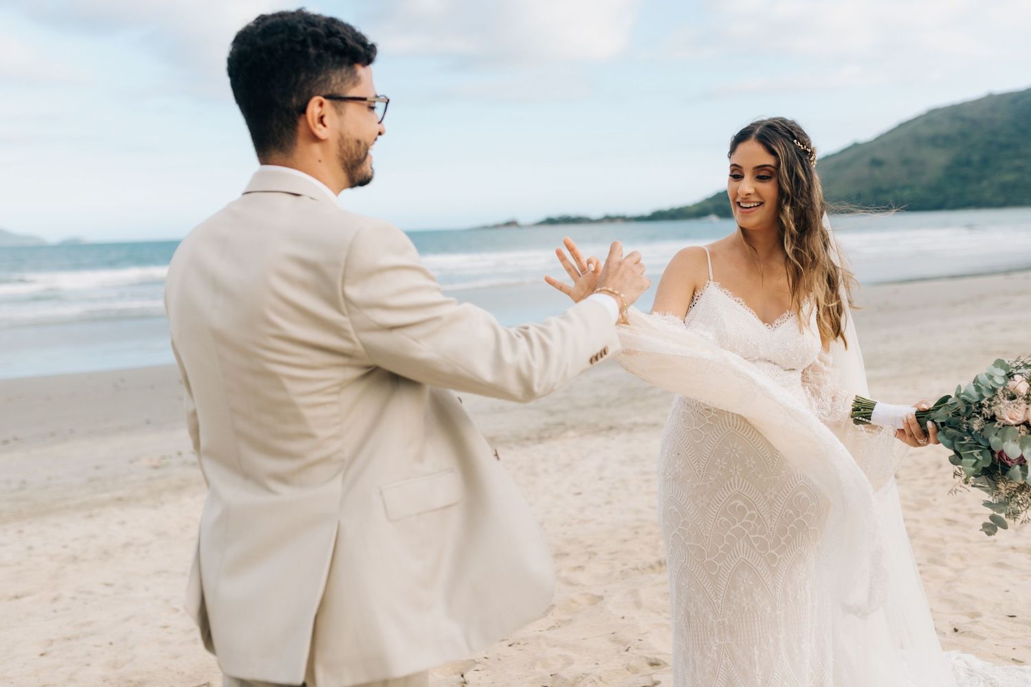 Joyful dance moment captured during beach wedding celebration.