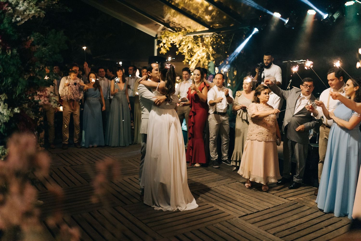 Wedding celebration with guests in formal attire watching the dance floor.