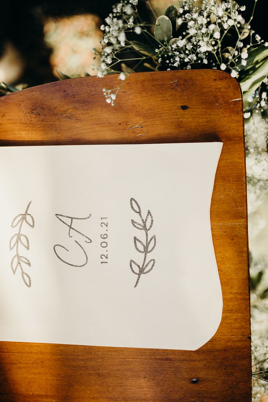 Close-up of minimalist wedding stationery with hand-drawn botanical elements.