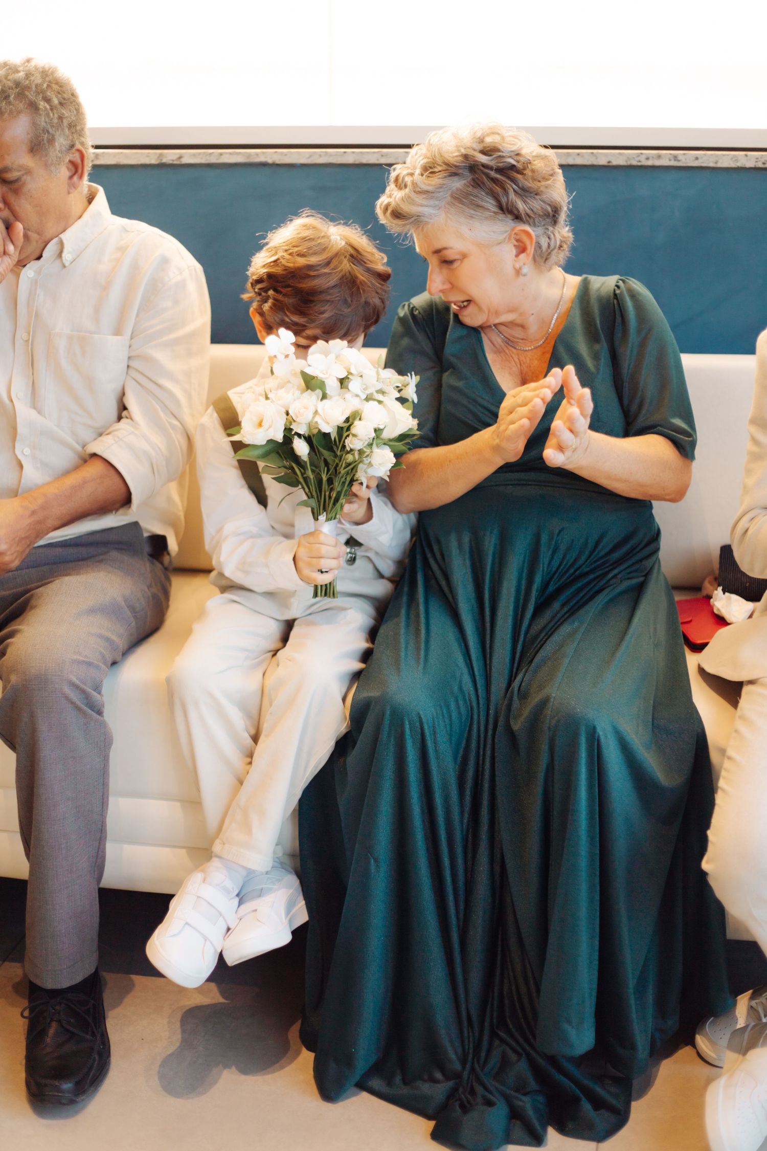 Elegant moment as couple in formal attire shares emotional first look holding white flowers.