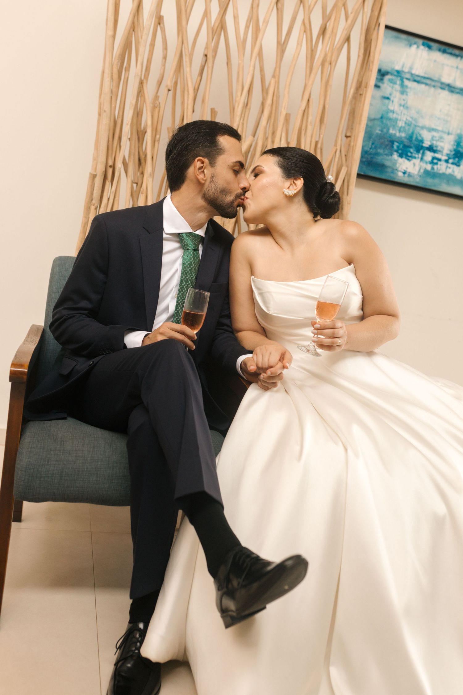 A couple shares romantic moments on a couch with decorative elements in the background.